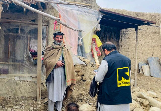 In Afghanistan,  IRC team member conducts an assessment with a man whose family is affected by the recent floods.