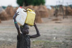 A boy fetches water in a camp in Ganyliel