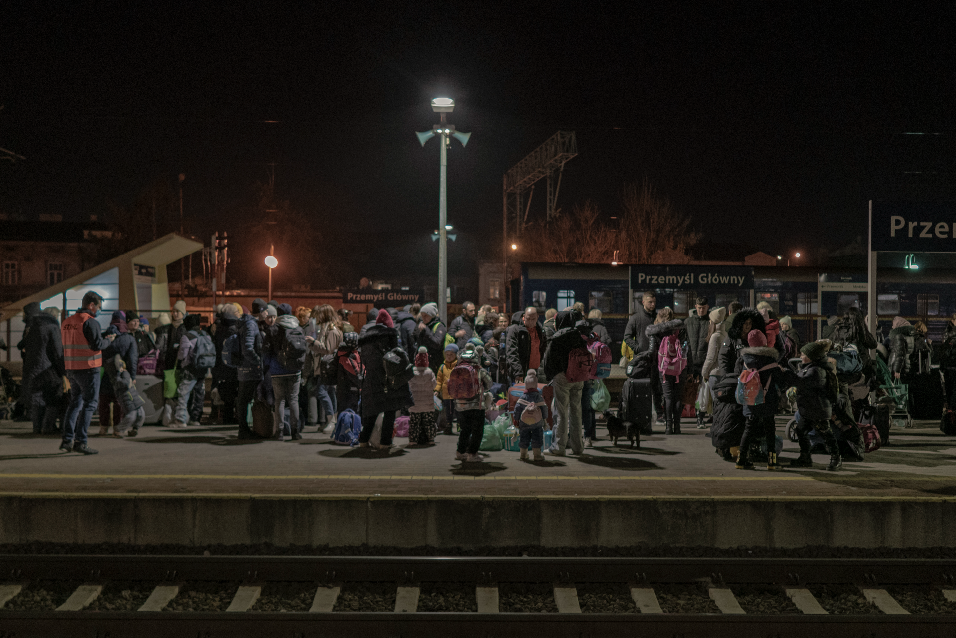 A large group of Ukranian refugees gather at a railway station in Poland after fleeing the war in Ukraine.