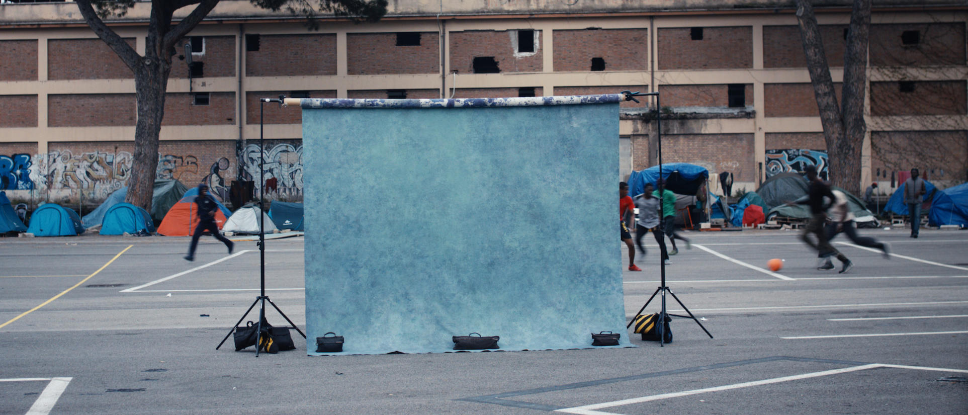 A photographer's backdrop ready for a shoot at a makeshift refugee settlement in Italy