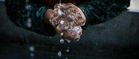 Person washing their hands.