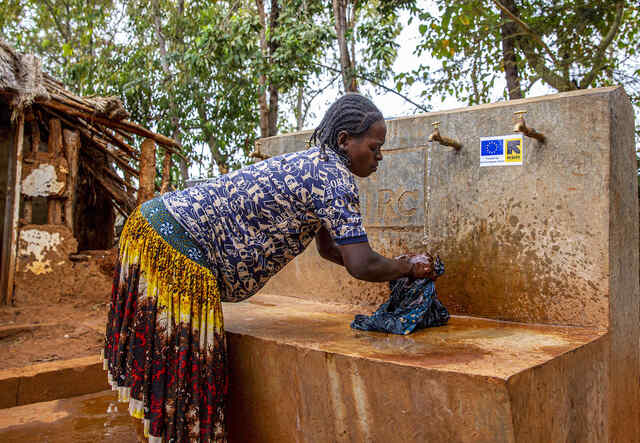 Tanite Gelgelo, 30, uses the watering taps funded through IRC's WASH program at Arfaide Health Center in Karat Woreda to wash her clothes.