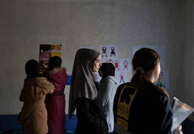 Sabah*, 15, center, stands in the middle of room surrounded by other Syrian refugee girls in the safe space where they take part in different kind of activities with the IRC WPE team.