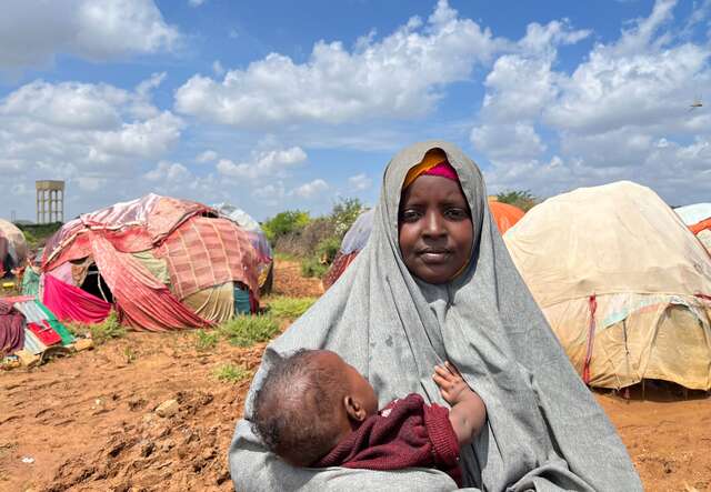 Fatuma holds her young child in her arms in a Somali camp for internally displaced people.