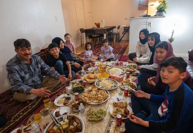 The Hussaini family sit around their prepared Iftar meal.