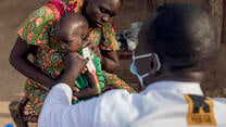 An IRC healthcare provider checks a baby for malnutrition in South Sudan