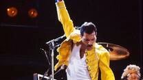 Freddie Mercury in performance, pumping his fist in the air