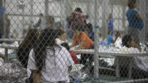 Families detained behind a chain-link fence inside a U.S. Border Patrol facility in Texas 