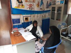 Farhiya and a patient in the office