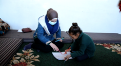 Reem drawing with IRC counsellor Fadia