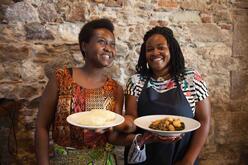 Two women presenting the food they made at the cooking workshop on Lesvos