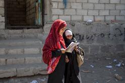 Two girls reading a book together