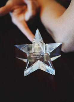 star shaped award given to Nadeana by the IRC for 20 years of service.