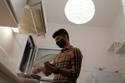 Young adult cooking in a Supported Independent Living (SIL) apartment