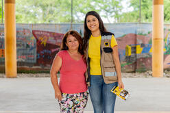 Aracely stands alongside an IRC staff member