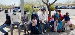 Sangam sits with his clients on an outdoor bench