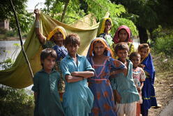 A family is seen pitching a tent as a temporary shelter in Mirpur Khas district of Sindh, Pakistan