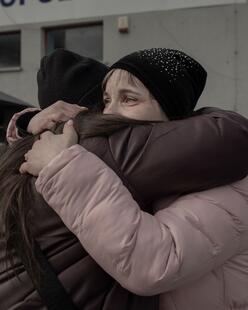 Two Ukrainian family members hugging each other