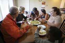 Group of people sitting around the dinner table.