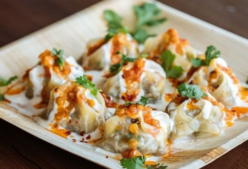 An Afghan dish of meat filled dumplings with a yogurt and chili sauce with herbs.