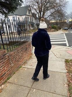 A woman standing on the sidewalk