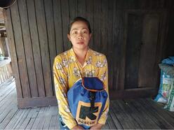 Daw Aye Htwe holding her IRC dignity pack in Myanmar