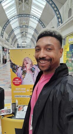 Person standing in front of an IRC banner