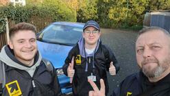 Three people wearing jackets with an IRC logo