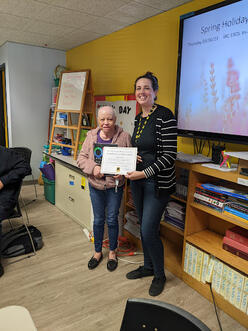 ESOL instructor Jessica Mlynar and student Marta holding an Oxford Picture Dictionary.