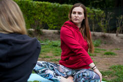 Khrystyna teaching a private yoga class in a city center park.