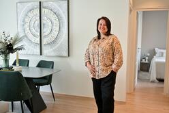 Photo of Alisa standing in a smartly decorated room