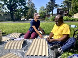 IRC Staff and IRC client building the raised garden bed together