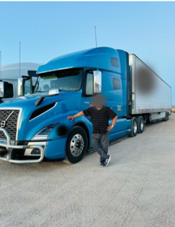 Ahmad standing in front of his truck 