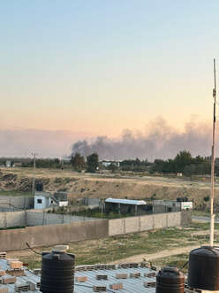 Plumes of smoke dot the sky after a bomb was dropped near the emergency medical team's housing complex.