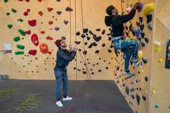 IRC staff and refugee climbing