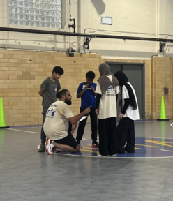 IRC staff with summer academy students about to play sports.