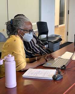 Nathalie searching for jobs with a client   Photo Credit: Josh Phillips, IRC Intern 