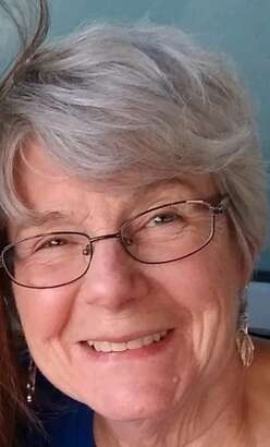 April is captured in this headshot smiling.