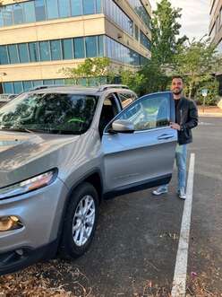 Ramon posing with his car