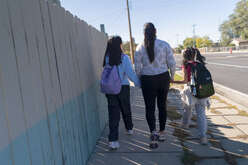 A women walking with her children