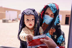 Young boy holding packet of RUTF food supplement