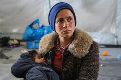 A mother and child stranded in Greece in a shelter at a refugee site.