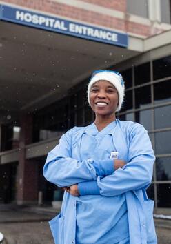 Nabila standing outside a hospital entrance