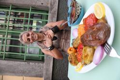 Jacqueline sitting in front of the food that she has prepared