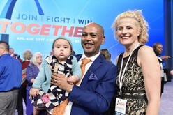 Tefere Gebre stands with his wife and holds his baby daughter