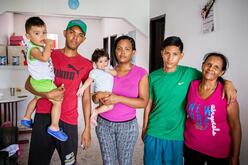 Cibel holds baby Diana in a family photo with her two sons and her aunt and nephew