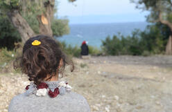 Seven-year-old Mubarak, a refugee on the island of Lesbos, looks out to sea.