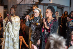 Nada Al-Rubaye addresses the crowd at HOPE Couture with her models. 