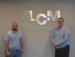 Asylees from Venezuela standing in front of V.L.C.M. sign.