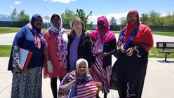 Volunteer, Janet, standing with a number of refugee women.